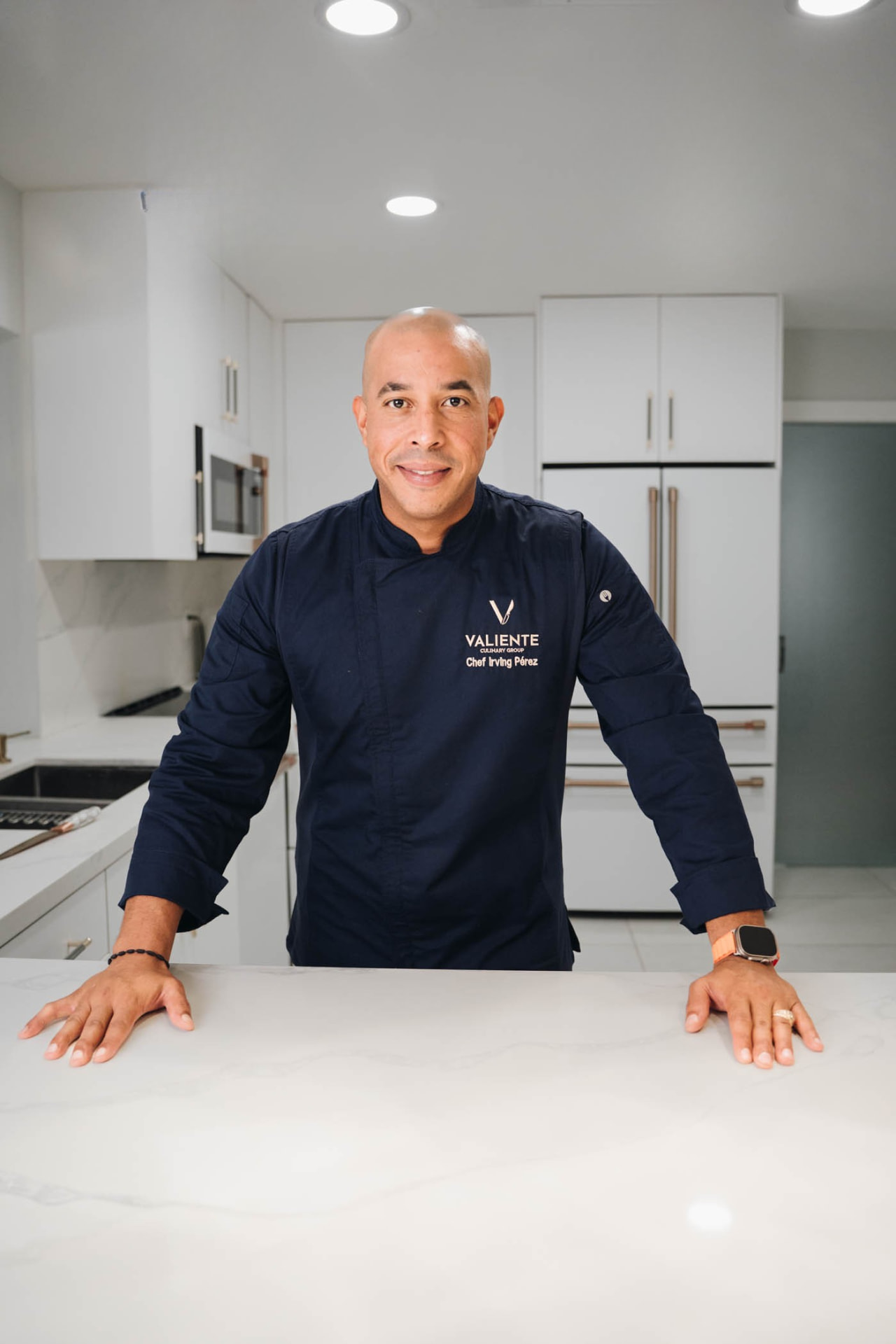 Chef Irving Perez standing behind a kitchen counter
